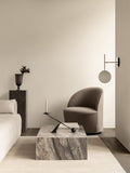 Audo Copenhagen Loose Cover for Tearoom Chair, With Swivel, minimalist living room with a gray Tearoom Lounge Chair, a Plinth Low marble table, and a TR Bulb Suspended Wall Lamp