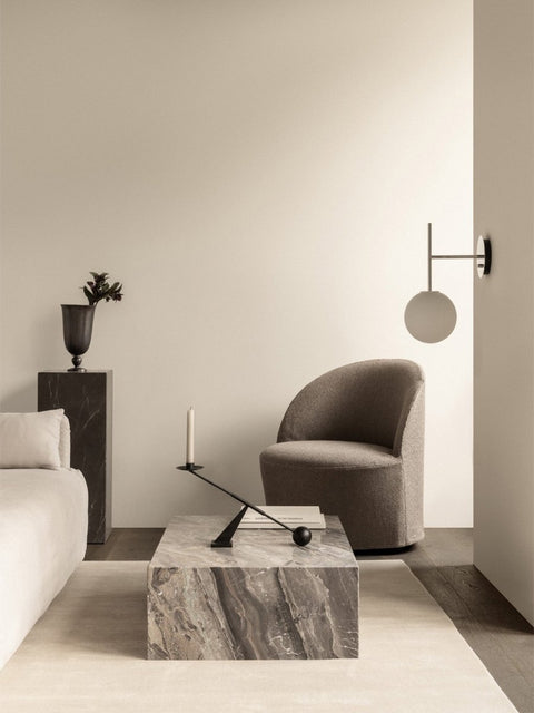 Audo Copenhagen Loose Cover for Tearoom Chair, With Swivel, minimalist living room with a gray Tearoom Lounge Chair, a Plinth Low marble table, and a TR Bulb Suspended Wall Lamp
