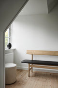 Minimal nook with Borge Mogensen 3171 oak bench and black leather seat, clean Nordic interior