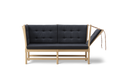 Front view of Borge Mogensen Spokeback Sofa by Fredericia in oak soap with charcoal tufted cushions Scandinavian modern sofa