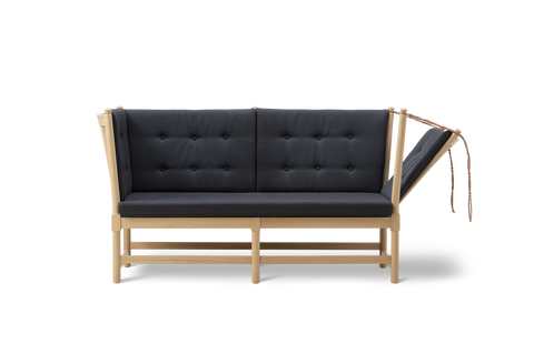 Front view of Borge Mogensen Spokeback Sofa by Fredericia in oak soap with charcoal tufted cushions Scandinavian modern sofa