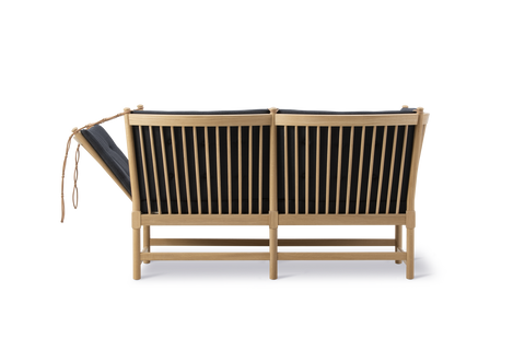 Rear view of Fredericia Spokeback Sofa in oak with black Vidar upholstery showing spindle back and adjustable side by Borge Mogensen