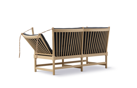 Rear view of Borge Mogensen Spokeback Sofa by Fredericia showing oak spindle back and adjustable side in black upholstery