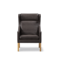Front view of Borge Mogensen Wing Chair in dark brown leather with high back and cushion, oak legs, modern Scandinavian furniture, Canada