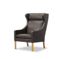 Angled view of Borge Mogensen Wing Chair, dark brown leather and oak legs, sculpted wings, classic Danish design lounge chair, Canada