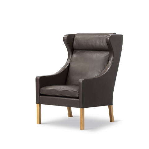 Angled view of Borge Mogensen Wing Chair, dark brown leather and oak legs, sculpted wings, classic Danish design lounge chair, Canada