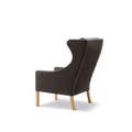 Rear angled view of Mogensen Wing Chair showing curved profile, dark brown leather and oak legs, Fredericia Scandinavian furniture, Canada