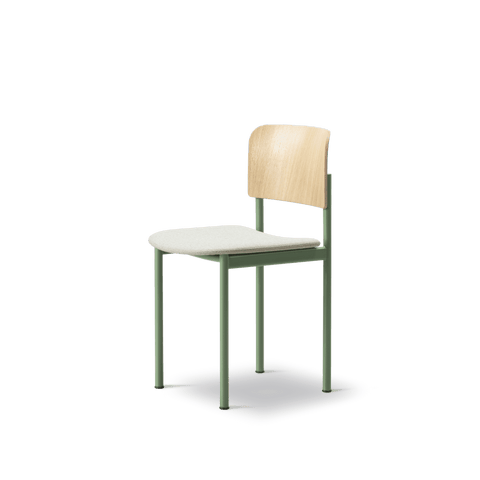 Angled side view of PLAN Chair by Fredericia with upholstered seat and oak veneer backrest on green frame