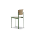 Side profile of PLAN Chair by Fredericia with upholstered seat and green steel legs, highlighting its minimalist design