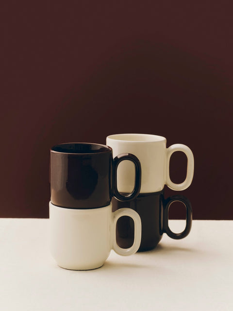HAY Barro Cups, Off-White, terracotta cups, cream and dark burgundy cups stacked in pairs against a deep burgundy backdrop