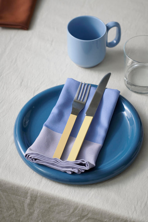 HAY Barro Cups, Light Blue, terracotta cups, one cup on white linen with a deep blue plate, lavender napkin and yellow handled cutlery