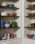 HAY Barro Bowls, Natural, glazed terracotta tableware, stacked on dark wood shelves in terracotta, blue, green and cream