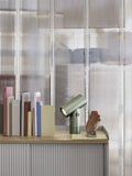 Muuto Beam Table Lamp on wooden desk, showcasing sleek modern aesthetic