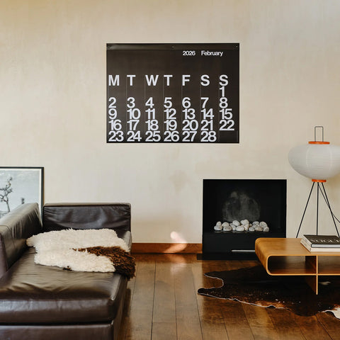 Large 2026 Stendig Calendar hanging above a sofa in a modern living room