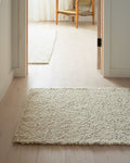 white boucle runner on oak floors