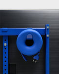 Pedestal Cable Bagel in Ultra Marine, mounted on the crossbar behind a screen with the cable wound through