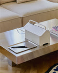 Pedestal Cable Villa in Pearl, steel cable box on wheels, standing on a desk beside a notebook and a pen