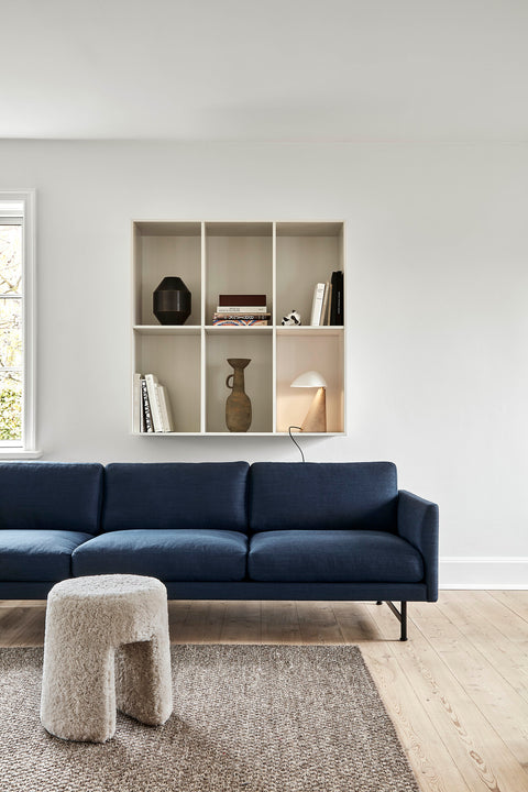 Fredericia Calmo 3 Seater sofa in navy with boucle stool and built in shelf in a Scandinavian living room
