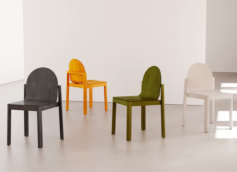 Collection of colorful Cleo Chairs by Edits Furniture in black, yellow, green, and white