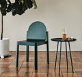 Green Cleo Chair by Edits Furniture beside matching side table and glassware