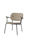 Audo Copenhagen Co Lounge Chair, Fully Upholstered in beige bouclé with a black steel frame and dark oak armrests, front-angle view