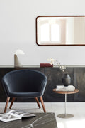 scandinavian modern interior with lounge chair and end table in living room 