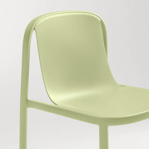 Blu Dot Decade Chair in celery green recycled plastic, close-up showing the molded seat, back, and curved frame