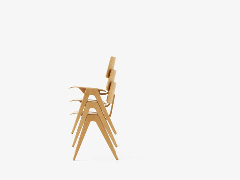 Profile view of stacked Daystak RD1 Side Chairs by &Tradition in natural beech