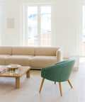 Nanna Ditzel Lounge Chair in green with Fredericia Nami sofa and oak coffee table in a bright Scandinavian living room