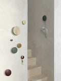 Muuto Dots wood wall hooks in stylish hallway, perfect for coats and accessories in modern Scandinavian interiors.