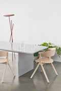 Pair of Circus Chairs by EDITS, Canadian furniture company, styled with minimalist dining table and greenery.