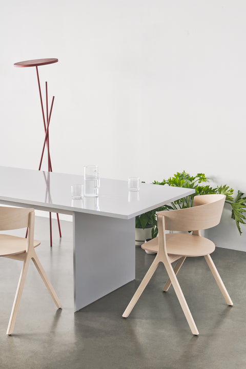 Pair of Circus Chairs by EDITS, Canadian furniture company, styled with minimalist dining table and greenery.