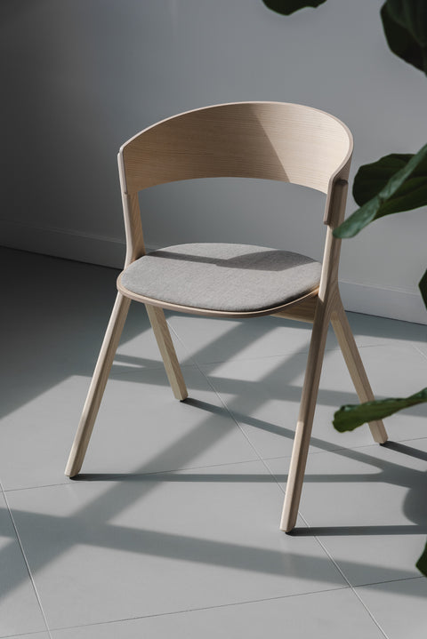 Modern Circus Chair by EDITS, Canadian furniture brand, natural wood with grey upholstered seat.