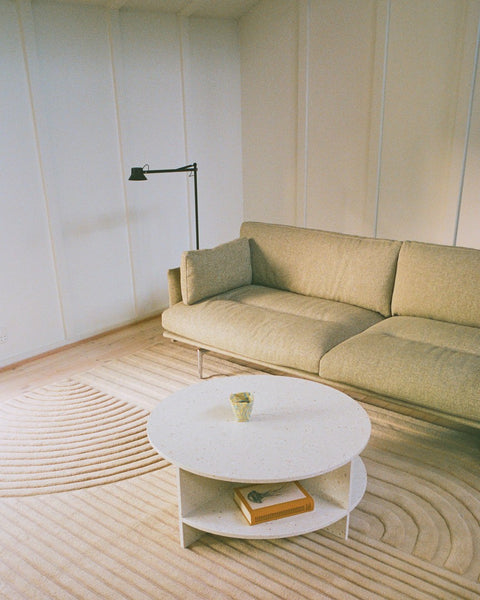 Muuto Halves Coffee Table in off white terrazzo styled in living room with Outline Sofa and Relevo rug