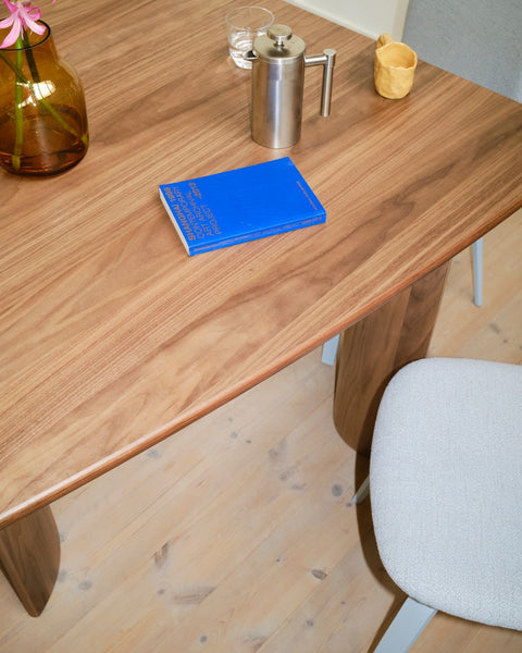 Muuto Re Norm Table 130 in walnut veneer by Maria Bruun close up of tabletop and sculptural legs