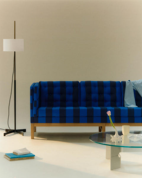 Fredericia JG Coffee Table beside blue tufted sofa Danish modern furniture