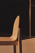 Side profile of natural oak Cleo Chair by Edits Furniture with sculpted backrest