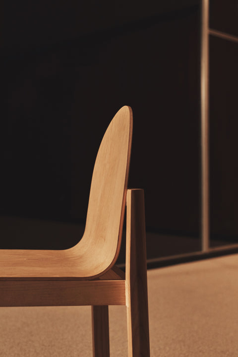 Side profile of natural oak Cleo Chair by Edits Furniture with sculpted backrest