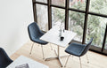 Modern café setting with two Eyes 4-Leg Tube Base chairs by Fredericia around a marble table near large windows