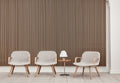 Three Fredericia Eyes Lounge Chairs in light grey with oak arms and legs beside a small table and lamp, slatted wood wall backdrop