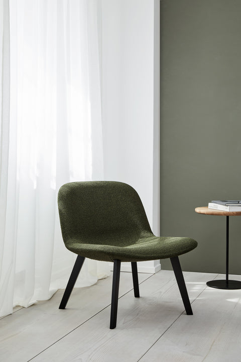 Fredericia Eyes Lounge Chair in green textured fabric with black oak legs in a Scandinavian modern living room