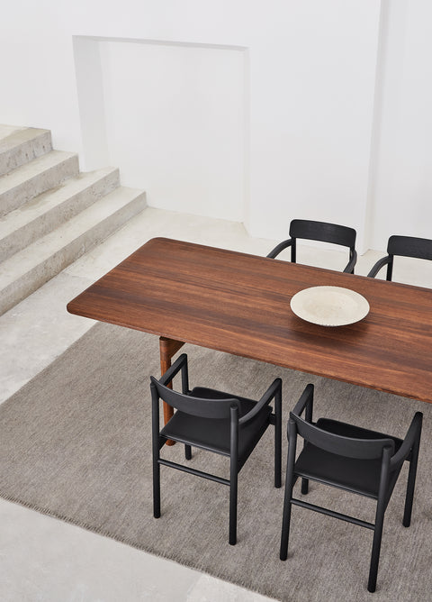 post dining table in smoked oak and post dining chairs in lacquered black oak by cecile manz for fredericia furniture