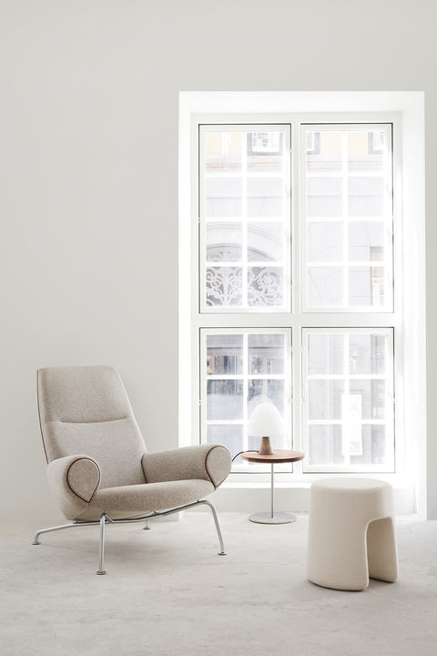 Queen Chair by Fredericia in neutral wool with contrast piping Sequoia stool and Pal side table bright Nordic interior