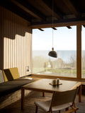 Finn Juhl Elements pendant lamp in white by Louis Poulsen illuminating Nordic living room with coastal view over table Canada