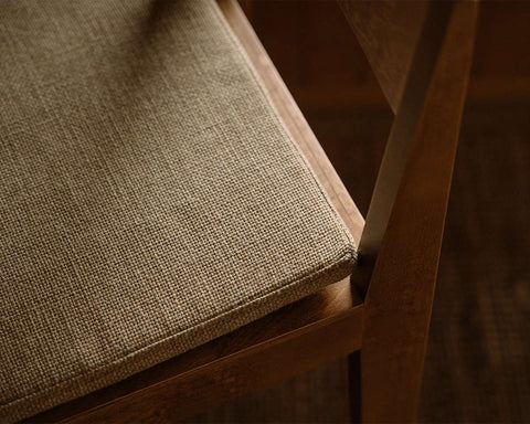Frama Bar Chair 01 Cushion in Camel, close view of the woven seat pad sitting on the seat of a dark wood bar chair