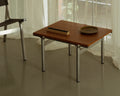 Frama Union Side Table in Warm Brown Ash and Aluminum, wood topped table by a sheer curtain holding a shallow dish and a dark ridged block