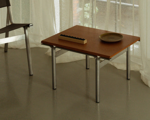 Frama Union Side Table in Warm Brown Ash and Aluminum, wood topped table by a sheer curtain holding a shallow dish and a dark ridged block