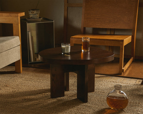 Frama Farmhouse Side Table in Dark Oak, dark oak table holding two drinking glasses on a woven rug with a glass flagon beside it