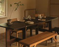 Frama Farmhouse Trestle Table in Dark Oak, long dark plank table set with plates and glassware, oak chairs and a pale bench beside a window