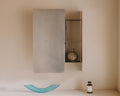 Frama Sheet Cabinet in Stainless Steel, steel wall cabinet with one door open showing shelves, a blue glass dish on the ledge below